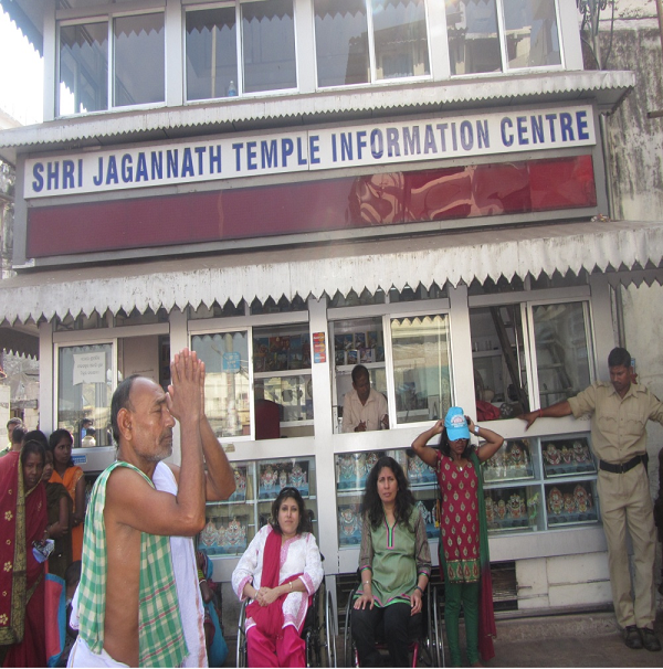 Neenu and Sunita stranded outside Jagannath Puri Temple office with a priest praying on the side and policeman standing, not allowed to go inside